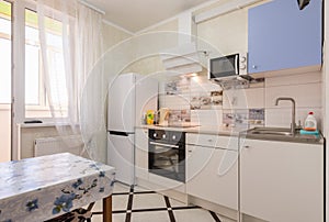 The interior of a small kitchen in the apartment photo