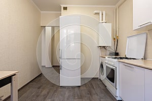 Interior of a small kitchen with a gas boiler photo