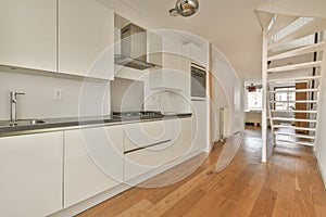 The interior of a small kitchen in white tones