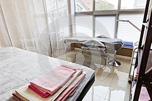 interior of the spa salon a couch with a clean one and towels behind a screen in a separate office