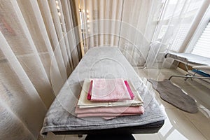 interior of the spa salon a couch with a clean one and towels behind a screen in a separate office