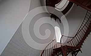 Interior Spiral Staircase and arched window inside Piedras Blancas Lighthouse on the Central California Coast