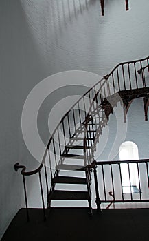 Interior Spiral Staircase and arched window inside Piedras Blancas Lighthouse on the Central California Coast