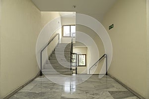 Interior stairs of an office building with polished white marble floors