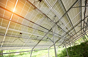 Interior of stand-alone photo voltaic solar system secured on metal rear legs on green grass