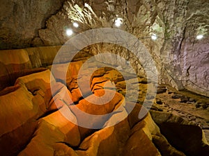 The interior of Stopica cave with tufa bathtubs illuminated with colored light, is located on the slopes of the Zlatibor mountain