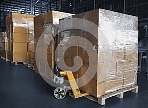 Interior of storage warehouse. stack of card board boxes with hand pallet truck. shipping distribution warehouse. cargo shipment.