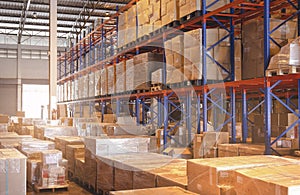Interior of storage warehouse with tall shelves. Cargo shipment boxes.