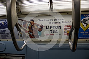 Interior of a subway train with multiple banners