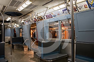 Interior of a subway train with multiple banners