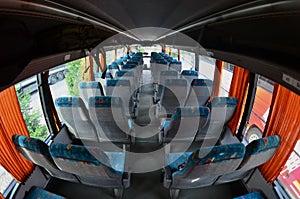 Interior of the tourist bus for excursions and long trips. A lot of free seats and places for small luggage photo