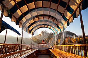 Interior of traditional pletna boat on lake Bled with old castle on the cliff, Bled, Slovenia.