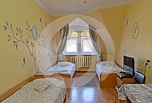 Interior of the triple hotel room with a portrait of the Russian poet Sergey Yesenin on a wall