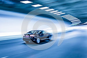 Interior of an urban tunnel with car,motion blur