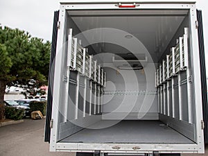 interior van of an empty panel truck with large doors open on empty place small vehicle