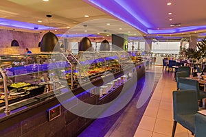 Interior view of beautiful hotel restaurant with a lot of food for turists. Tourism concept. Food and drinks concept. photo