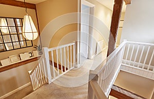 Interior View Of Beautiful Stairs And Landing With Exposed Wooden Beams In Family House