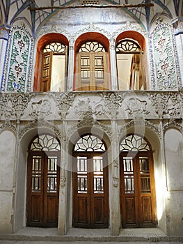 Interior view of Borujerdi historical House with Tile decoration with complex floral and fine patterns on walls , Kashan, Iran