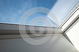 Interior view and close-up detail at closed white Tilt Window Skylights at attic.