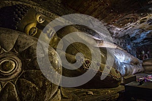 Interior view of the Dambulla Cave Temple in Sri Lanka, featuring a statue of the Buddha