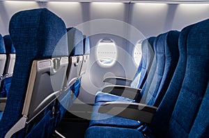 Interior view of economy coach seats inside of passenger airplane
