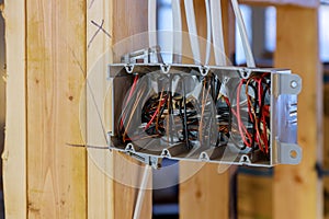 Interior view of a electrical box with wiring in a new home under construction wooden beams