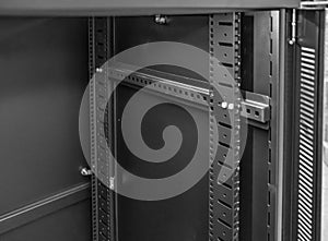 Interior view of a front vertical mounting post used to attach Networking and Server hardware, seen within a cabinet.