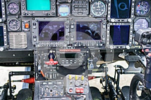 Interior view of helicopter Agusta cockpit with control pedals, dashboard, displays, selected focus