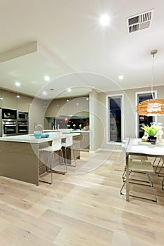 Interior view of a house with wooden floor and kitchen next to t