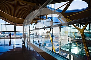 Interior view of the Madrid Barajas International Airport with glass windows photo