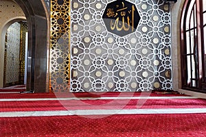 An interior view of a mosque featuring a beautifully decorated wall