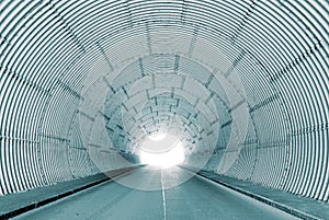 Interior view of a tunnel with bright tunnel exit