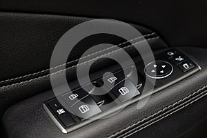 Interior view with widows buttons on the door of luxury very expensive new white Mercedes-Benz GLS 350d SUV car stands in the