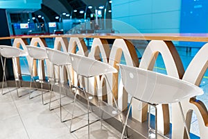 The interior of the waiting room. A row of chairs near the bar shelf