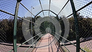 Interior of a walkway bridge with metal mesh