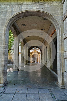 the interior walkway of an old - fashioned stone building with large archways