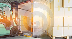 Interior of warehouse dock, Forklift loading pallet into contain, truck docking load cargo at warehouse photo