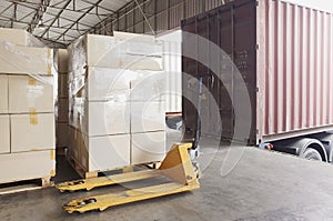 Interior of warehouse dock. Large shipment pallet boxes waiting for load inti container truck.