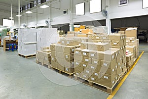 Interior of a warehouse with pallet stacker, boxes.