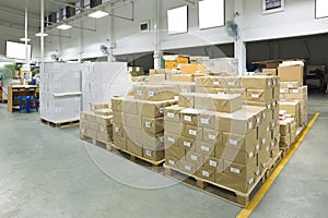 Interior of a warehouse with pallet stacker, boxes. photo