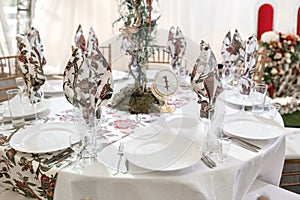 Interior of a wedding tent decoration ready for guests. Served round banquet table outdoor in marquee decorated flowers