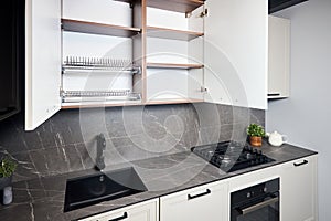 Interior of white and grey kitchen, horizontal linear layout. Luxury modern fitted flat design kitchen with opened