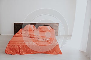 The Interior of the white room with a bed with red