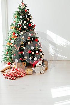 Interior white room with Christmas tree window with new year gifts