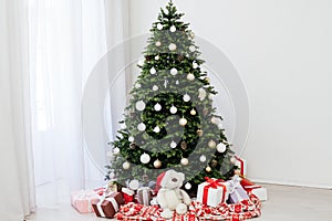 Christmas interior of the white room green Christmas tree with red gifts for the new year decor winter holiday