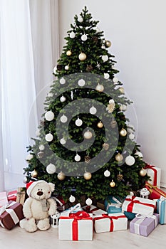 Christmas interior of the white room green Christmas tree with red gifts for the new year decor winter holiday