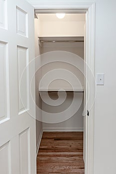 Interior white solid wood closet with wood shelves