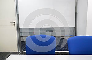 Interior of whiteboard and meeting chairs in conference room