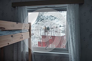 Interior of wooden bed with window and curtain on cozy day