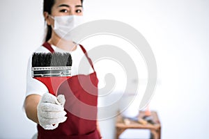Interior working, Painter hand in white glove painting wall with